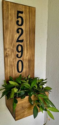 Upgrade your entryway and show your numerical address with this decorative wood sign and plant holder.