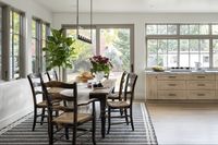 Dining nook design inspiration with white oak floors, white oak cabinets, marble cournetops and windows and sliding glass doors to backyard in Boulder Colorado