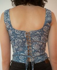 Ships 6-8 weeks after June 1st. Our Block Printed Corset Top was inspired by the ever trending corset silhouette. It was produced by artisans in North India with sustainable hand stamping techniques and created with 12 and half hours of work in South India. 100% Cotton Model in picture #1 & video s is wearing a M Model in picture #2 & video is wearing a S