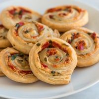 Cheesy Roasted Pepper Pinwheel Recipe - try with tomato paste, oregano, chopped ham, chopped capsicum & grated cheese for pizza pinwheels