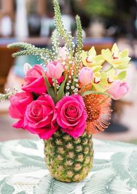 For a tropical flair floral arrangement or flower bouquet consider a natural vase such as this gorgeous florar arrangment in a pineapple vase. Or a coconut! Follow the link to completely-coastal.com to check out all 28 coastal floral arrangements!