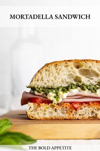 Indulge in the ultimate Mortadella Sandwich featuring roasted tomatoes, creamy stracciatella, and homemade pesto. Perfect for lunch or an summer gathering. Delicious, quick, and easy to make.