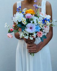 Beautiful spring wildflower inspired bouquet that has a exquisite design and details which would make a wonderful accessory for your special day. Lush roses in blue, purple, pink and white hues.  Available with ribbon or twine wrapped base.  X1 Bridal Bouquet  X1 Matching boutionierre  You have the option to wrap the base of the bouquet with twine, ribbon or both the choice is yours. :) If you would like any alterations or custom requests we would love to hear your ideas before you place your order. Please note these are preserved- artificial flowers and accents and are not fresh flowers.