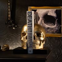 "Our Skull Bookends are handcrafted pieces of art for lovers of gothic home decor and the macabre. Ideal gothic gift for those dark at heart, and particularly those with a spooky book collection! Adorn your haunted home with the beautifully peculiar.   The Skull Bookends are handmade by Artisans (Us! The Blackened Teeth Family) in our South Wales UK workshop. We're a family owned and run business, established in 2018 and we've been embellishing the macabre ever since.  Materials:  Hand-cast usin