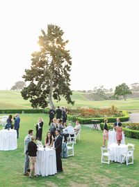 Guests during cocktail hour outside at a rustic upscale venue on a golf course in San Diego, Lodge at Torrey Pines wedding, photography by Cavin Elizabeth Photography