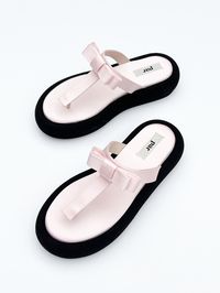 Get ready to elevate your shoe game with these platform sandals featuring a ribbon bow detail. Details 2" platform thong sandal made with pink satin and black suede leatherOuter materials: satin, suedeLining: goat leatherOutsole: rubberMade in Spain