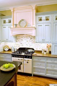 Pale Blue Cabinets Paired with Sparkly Subway Backsplash and a Hint of Pink Fireplace.