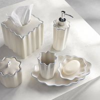 Crafted from cream-colored porcelain and featuring a whimsical scalloped design, the Le Marais collection is an elegant addition to any bath. Along the top of each collection piece is a subtle-trim detailing that further accentuates the scallop shape of this timeless accessory set.