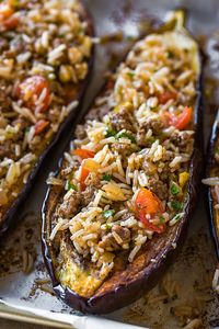 This savory stuffed eggplant with middle eastern spices and a garlic tahini sauce is a delicious and beautiful meal, one full of textures and healthy ingredients. | thecozyapron.com #easydinnerrecipes #recipes #dinnerrecipes #stuffedeggplantrecipes #stuffedeggplant #roastedeggplant #roastedeggplantrecipes