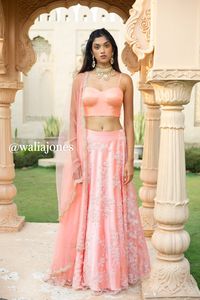 Peach bead embroidered skirt with peach bustier with pearl work and net dupatta with scallop embroidery (Skirt has cancan).