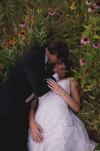 Here is your cue to take your bridal portraits in a wild flower field | Wisconsin August wedding at Rustic Manor 1848 Hartland Wisconsin. These two were literally the best. Their day was perfect with an outdoor ceremony in an open field, and their reception was inside the barn. Their choice of couple sunset portraits ended in a wildflower field, and we could be happier with how they turned out!