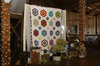 Family quilt used as ceremony backdrop. Photo by Wanda Hunt