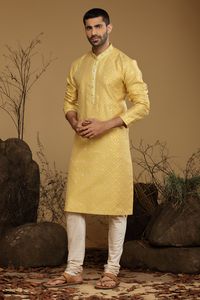 Amber Yellow Blended Benarasi Silk Kurta Set Kurta Set Traditional  Wear  Care Instructions: Dry Clean Blended Benarasi silk kurta with motifs & front potli placket. Top Details: Color- Yellow, Fabric - Blend slik Bottom Details Color - Cream, Style - free size Chudidar, Fabric -Dhupion Silk Package Include: Kurta and Pajama Additional Information : - As this Sherwani/Waistcoat/Kurta is stitched & made as per orders requested only, So there is NO RETURN & NO EXCHANGE on this product. Kindly Choo