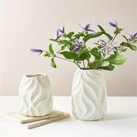 The white flower vase is handmade of clay, with a frosted surface, natural and simple, and a unique appearance. Add more warmth, elegance, and romance to your home.