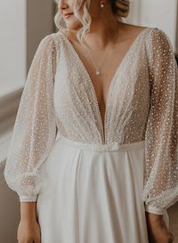 This stunning C2023-LS33H blouson long sleeve plus size wedding gown is perfect for your special day. The v-neck design and figure-defining cinched waist are sure to flatter every curve, while the long sleeves add a touch of elegance. Look and feel beautiful on your big day! Have this #plussize #fashion #design made as shown. Or you can request modifications however you need. Our #American firm can also very easily create #bespoke #wedding #dresses using any of the #beautiful #photos you have sa