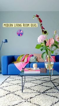  

Decor 
 • Blue sofa 
 • White rug 
 • Coffee table 
 • Table decor 
 • Books
 • Flowers 
 • Flower vase 
 • Throw pillows 
 • Throw blanket

