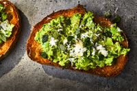 This Smashed Fava Beans on Toast with Pecorino and Mint recipe gets its flavor from fresh fava beans, lemon zest, and pecorino Romano cheese. Get the recipe from Food & Wine.