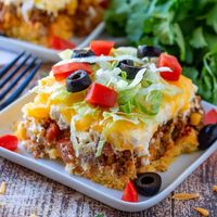 Cornbread Taco Bake is a cornbread base topped with seasoned ground beef, a creamy filling and topped with melted cheese! So good!