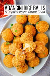 In this arancini recipe, rice balls are filled with herbs and spices, stuffed with mozzarella, breaded, and fried until melty and golden. 