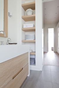 Minimalist bathroom with clean lines and matching shelves in open storage