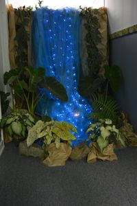 Waterfall at end of hallway. Hallway decorated as a rainforest.