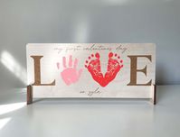 This DIY First Valentine's Day footprint/Handprint art is an aesthetically appealing first Valentine's Day keepsake. A great gift for an expecting mom or gifting it for grandparents this holiday season.   | DETAILS | - This listing is for one Valentine's Day sign - Two wood stands as pictured - Maple wood - Laser engraved  ** paint and hand/footprints are NOT included. ** Slight variation in natural woodgrain may occur as well as engraving. Have any questions? Feel free to message me :)