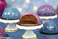 Galaxy Mousse Cakes - mini chocolate mousse cakes on a brownie, with a gorgeous galaxy mirror glaze on top! | From SugarHero.com