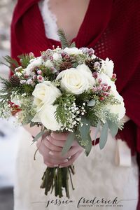 A beautiful winter bouquet with "frosted" hypericum berries, roses, winter greenery and seeded eucalyptus. jessicafrederickphotography.com