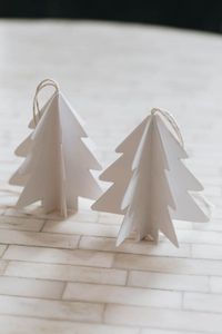 Beautiful 3D Paper Christmas Trees! Make your own DIY paper Christmas tree ornaments using dollar store supplies! Perfect for gift toppers, Christmas gifts, or your own Christmas tree decor! You'll love this modern Scandinavian style ornament idea! Beautiful idea for a modern, nordic, or farmhouse Christmas celebration! Ornaments that adults, kids or teens could make - and you could definitely use a Cricut too!