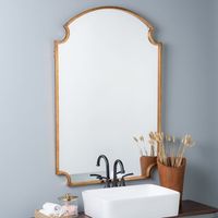 <p>This shapely wall mirror is set in a golden frame that brings timeless elegance to a room.</p>