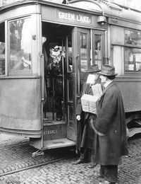 1918-1920: The Flu Epidemic}  December 1918 A Seattle, Washington streetcar conductor refuses entry to a commuter who is not wearing a mask. Precautions taken in the city required passengers to wear masks on public transportation. PHOTOQUEST/GETTY IMAGES