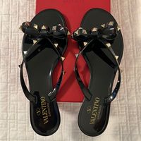 Nwt- Valentino Garavani Flip Flops- Never Worn! - Bow Detailing With Platinum-Finish Studs - Sole With Lace Motif - Heel Height: 5 Mm / 0.25 In. - Made In Italy - Size 38 However I Typically Wear A 7 And These Fit Me. - Have Box, Dust Bags, Etc.