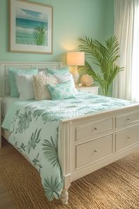 Seafoam Bliss offers a refreshing take on cozy bedroom green design with pale seafoam walls and white trim. Coastal-inspired decor and light wood floors add to the beachy feel. Click here for more Seafoam Bliss inspiration.