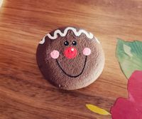 Gingerbread man face on a rock. Would make a cute paperweight for someone who loves Gingerbread men or Christmas. Hand drawn and hand painted with acrylic paint. Image displays artwork only, rock shape and size may vary.