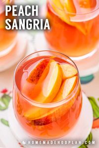 Peach Sangria! Celebrate the taste of late summer with this classic and crisp peach sangria. Perfect for entertaining, this recipe only uses five easy-to-find ingredients and can be made with fresh or frozen peaches. | HomemadeHooplah.com