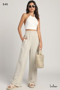 The sunshine is calling, and you must answer with the Lulus Hit the Breeze Beige Smocked Wide-Leg Pants! Lightweight, woven linen-blend fabric shapes these essential pants with a high, smocked waist and a pull-on silhouette. Twin diagonal seam pockets accent the relaxed pant legs before ending at wide hems. Fit: This garment fits true to size. Length: Floor length. Size medium Inseam: 32.00 Front Rise: 11.50 Waist: Fitted - elastic waist allows stretch. Hip: Loosely Fitted. Fabric: Fabric has no