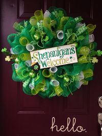 Welcome St. Patricks Day in style with this 26 Shenanigans Welcome deco mesh wreath. This wreath features three colors of mesh, shiny green