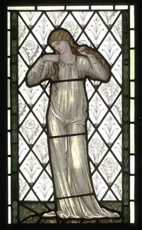 edward burne-jones (designer), morris & co (manufacturer), 1870 | stained and painted glass | framed 89.5x53.8 | a woman, full-length, both arms upraised holding her long hair | grass and flowers | background of quarries with alternate lilies and poppies | right and left narrow borders of formal tulips? | victoria & albert museum, london