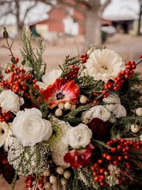 Wedding in a Winter Wonderland: Christmas Wedding Style Red and white florals mixed with evergreens for Christmas wedding perfection!