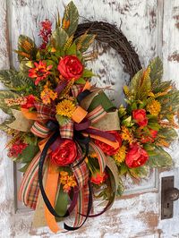 Fall Peonies with Wild Flower Wreath with Bow. A Variety of Greenery accents the floral. With a Large Fall Bow that accents the Fall Colors. Large Size. Fits standard size door or Larger doors. Approx 26" wide and 30" in length. Measurements may vary slightly( 1-2") depending on where you measure. Each One is hand made by me.  Depth is 5-6". This wreath actually is designed to match the hanging baskets I have in my shop.