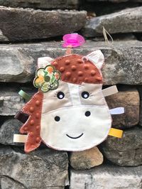 This adorable horse helps your little one keep up with her pacifier while providing a soft cuddly friend to snuggle with! Pacifier included but will hold any style of pacifier.  Can be personalized with baby's name 😊 We welcome custom orders!