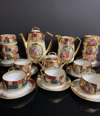 Extravagant coffee/tea service from the 1900s. Manufactured in the Karlsbad Bohemia factory. A breathtaking decor, each object is also provided with a romantic Victorian picture medallion, which makes it magical. In excellent condition. Not dishwasher safe. Consisting of: 1 jug H=22 cm 1 milk jug H=18 cm 1 sugar bowl H=18 cm 11 cups H=5.5 cm D=8 cm 11 saucers D=14.5 cm You can rely on careful packaging and proper delivery!