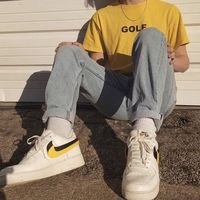 vintage men's yellow golf tee paired with vintage light washed jeans + nike airs