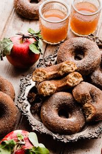 Apple Cider Donuts are the ultimate fall treat! Reducing the cider into a concentrated syrup (hands-off time!), and combining this with apple butter produces a deep apple cider flavor in these easy baked donuts. Warm donuts are brushed in a mixture of apple butter & reduced cider, and coated in apple pie spice sugar. Dare I say, they're even better than ones from the apple orchard!