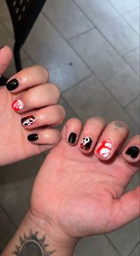 Scream inspired nails. Black and white nails with red splatter. Ghostface on ring finger. Glossy gel on natural nails.