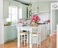 A lakefront cottage kitchen brings generations together in a space as cozy as the site's original cabin.