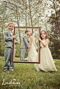 A Love-ly work of art! Ring-bearer and flower girl hold up a frame to "frame" the bride and groom. @Tommy Watson How cute would this be!