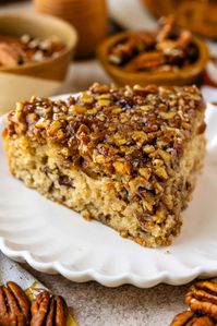 This Pecan Pie Cake combines the rich flavors of a classic pecan pie with a soft, spiced cake, topped with a gooey pecan caramel.