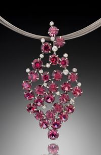 Glam Rhodolite Garnet Pendant is bold and timeless. In this modern pendant design, an array of richly colored rhodolite garnets and diamonds are delicately set in white gold.