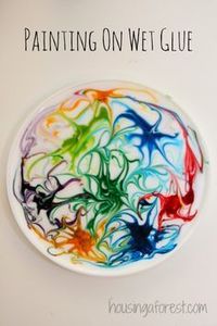 Painting on wet glue with food colouring. Once the glue has completely dried then peel it off, punch a hole in the top and hang with a string in a window...the result is a beautiful sun catcher!